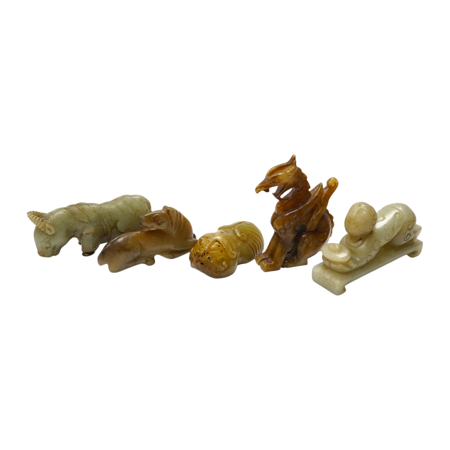 Four Chinese jade carvings, of a horse, cicada, a winged beast, a kneeling man, and a horned beast, longest 7cm. Condition - good